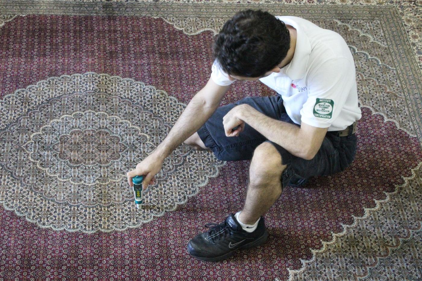 Technician testing dyes on a Persian rug before washing