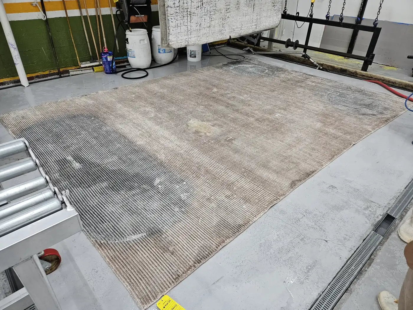 Large pale rug laid flat on the wash floor